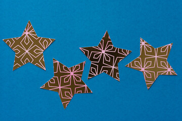 Sticker - gold and pink patterned paper stars on blue