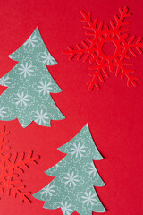 Wall Mural - red paper snowflakes and stylized paper holiday trees on red