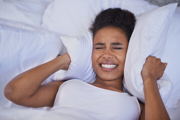 Wall Mural - Nothing is going to make me get up today. Cropped shot of a restless young woman lying in bed.