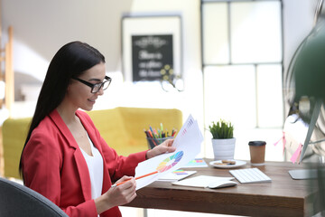 Poster - Female designer working at desk in office
