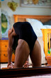 Black woman with dreadlocks spending time practicing yoga meditating and stretching