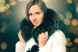 © yurolaitsalbert - portrait of beautiful young woman in winter jacket. Beautiful bokeh effect from a garland.
