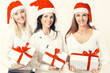 © yurolaitsalbert - group of female students in costume of Santa Claus with Christmas gifts .