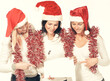 © yurolaitsalbert - group of female students in costumes of Santa Claus holding blank sheets