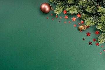 christmas decorations with stars confetti on green background. holiday pattern background.