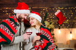 © be free - Man woman santa claus hats cheerful celebrating new year. Romantic ideas celebration. Merry christmas. Celebrating together. Celebrating winter holiday. Couple in love enjoy red wine. Idyllic date