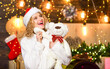 © be free - Plan where and how you are going to spend new year eve. Things to do before christmas. Woman with teddy bear toy christmas decorations background. Plan for some interesting Christmas activity