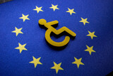 Disabled person sign on the EU flag. European accessibility act concept.