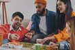 © gstockstudio - Happy young people playing board game while enjoying carefree time together