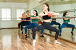 Barre instructor giving a group class at the studio