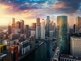Fototapeta Londyn - Panoramic sunset view of the residential and corporate skyscrapers at Canary Wharf and the Docklands, financial district of London, England