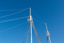 Sailboat Ship Mast On Clear Blue Sky Background, Viewed From Below