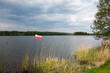 Polish flag on the background of the lake