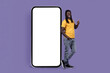 © Prostock-studio - Positive african american young man posing by huge smartphone, mockup