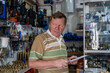 © sommersby - Thoughtful senior male customer shopping in hardware store