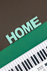 Wall Mural - Musical keys and decorative word home on a colored background.