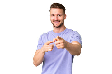 Wall Mural - Young handsome caucasian man over isolated chroma key background surprised and pointing front