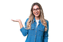 Young Uruguayan Woman Over Isolated Background Holding Copyspace Imaginary On The Palm To Insert An Ad