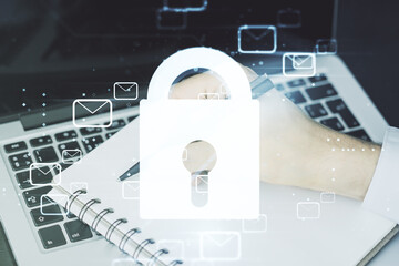 Poster - creative lock sketch with email symbols hologram and hand writing in notepad on background with lapt