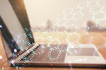 Poster - Double exposure of technology hologram with hexagon on laptop background. Research and development software concept