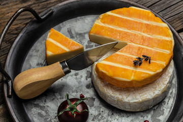 Wall Mural - cream Round brie or camambert cheese on a wooden board. Rougette cheese on a wooden background, banner, menu, recipe place for text, top view