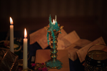 Wall Mural - Fortune-telling cards and burning candles on a table on mystic background 