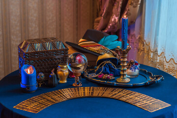 Wall Mural - Fortune-telling cards and burning candles on a table on mystic background 