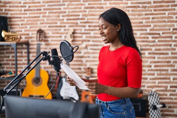 Sticker - Young african american woman artist singing song at music studio