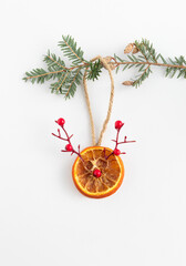 Wall Mural - Dried carved citrus slice for Christmas tree on white background. Christmas bauble concept. Holiday decor in eco style. Flat lay, top view. Copy space. 