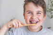 © kostikovanata - Happy boy child cleaning teeth with braces use wooden eco friendly toothbrush healthy lifestyle