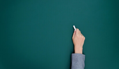 Wall Mural - Businesswoman hand writing chalk on blackboard