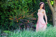 Young woman in a pink dress in nature
