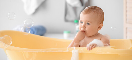 Wall Mural - Adorable little baby in bathtub at home