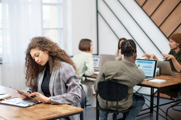 Wall Mural - young business woman with a digital tablet working in a coworking center.