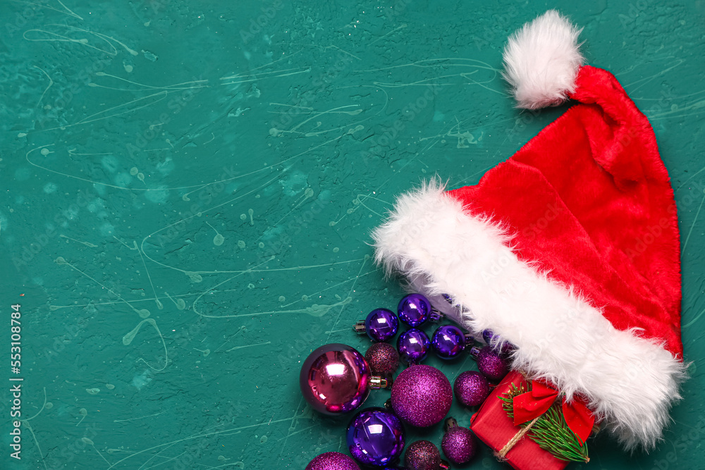Composition with Santa hat, beautiful Christmas balls and gift on color background