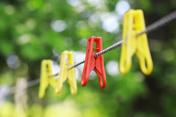 Wall Mural - Clothespins on a clothesline in summer. Dry clothes outside. Clothes on a rope.