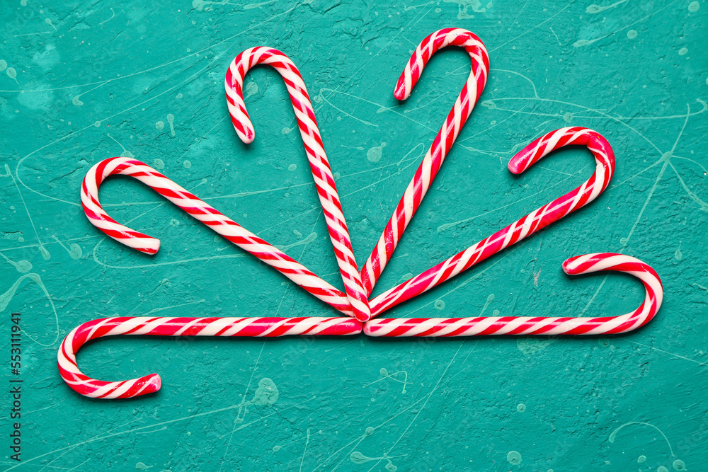 Composition with tasty candy canes on color background
