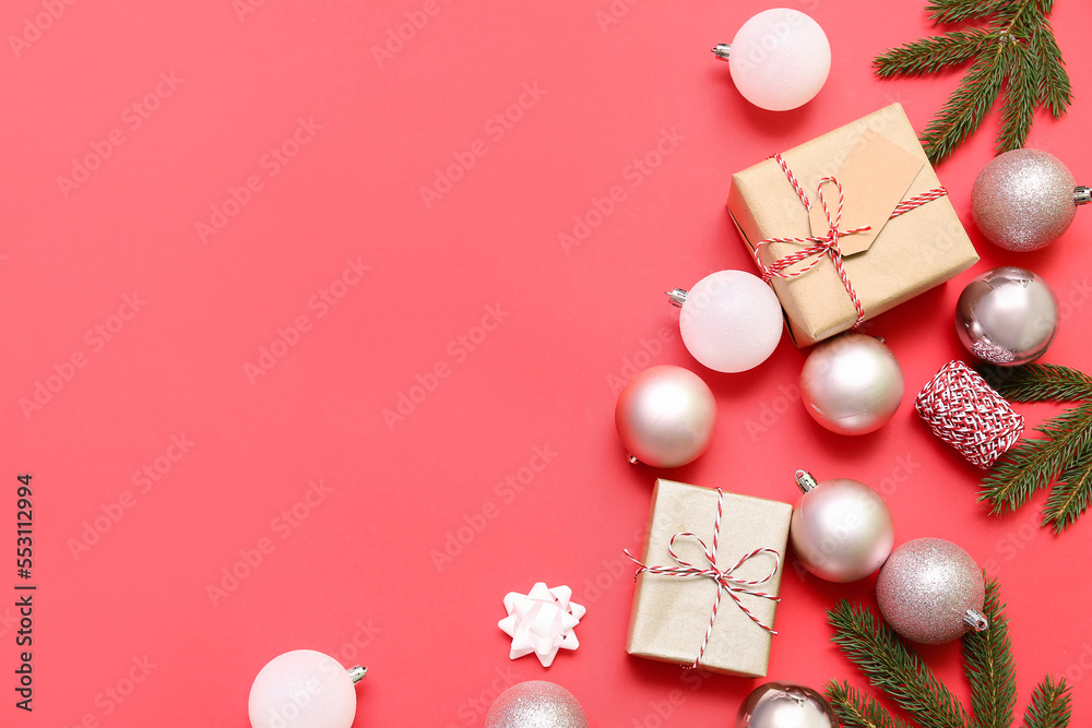 Composition with Christmas gifts, balls and fir branches on red background