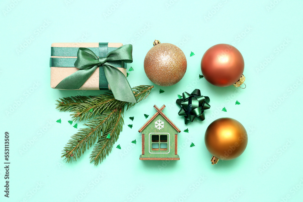 Composition with beautiful Christmas decorations, gift and fir branches on color background