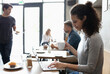 © Westend61 - Smiling freelancer working on laptop drinking coffee at cafe