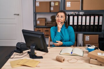 Canvas Print - Middle age hispanic woman working at small business ecommerce on customer support serious face thinking about question with hand on chin, thoughtful about confusing idea