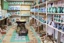 Various Ceramic Pieces Arranged On Rack In Workshop