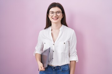 Canvas Print - Young caucasian woman holding laptop with a happy and cool smile on face. lucky person.