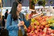 © PR Image Factory - Women choosing peaches in produce department of supermarket. lady buying fresh organic fruit for healthy.