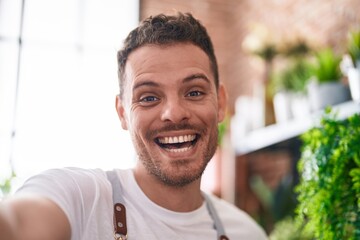 Sticker - Young hispanic man florist smiling confident make selfie by camera at florist