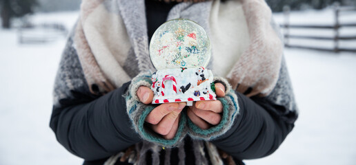 Sticker - woman holding Christmas decoration in snow