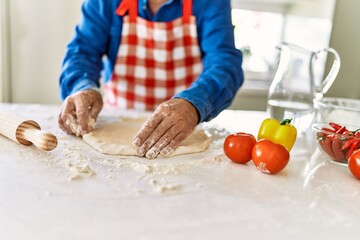 Poster - Senior man keading dough with hands at kitchen