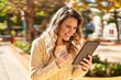 © Krakenimages.com - Young woman smiling confident using touchpad at park