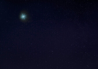 Wall Mural - Bright blue star for Christmas in the night sky