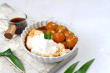 Bubur Sumsum Biji Salak or bubur Candil, Indonesian rice flour porridge with sweet potato glutinous rice balls, served with palm sugar sauce 